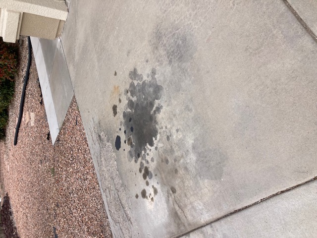 Heavy Diesel engine oil stains removed from concrete driveway in Prescott Valley Arizona using environmentally safe cleaner with hot water pressure washer